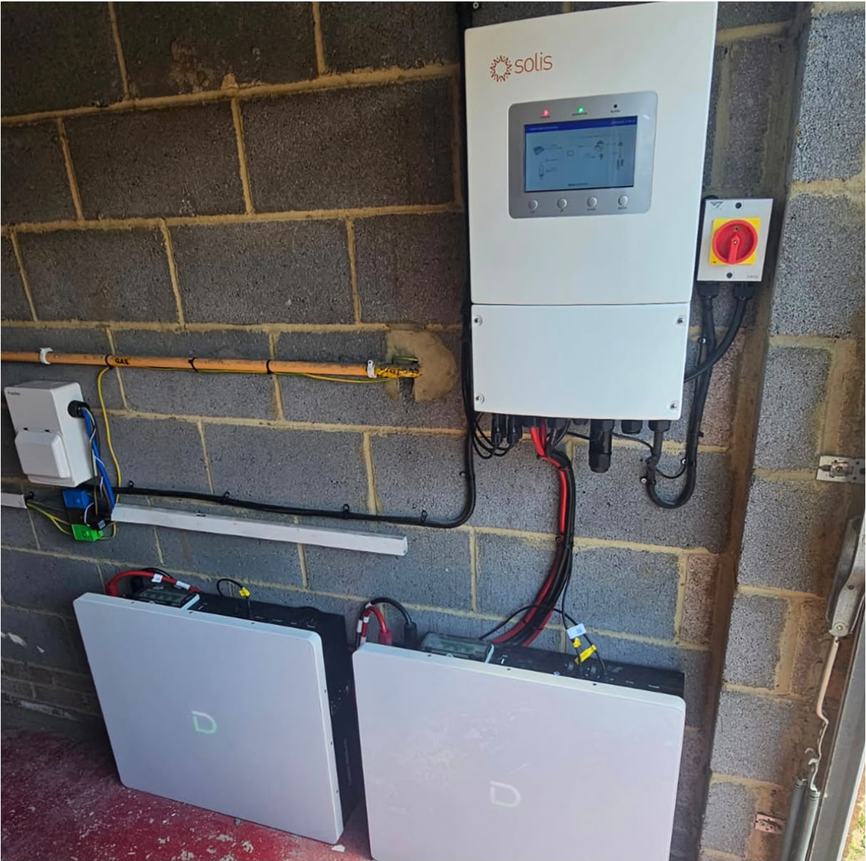 Solis hybrid inverter and two wall-mounted home battery storage units in a garage