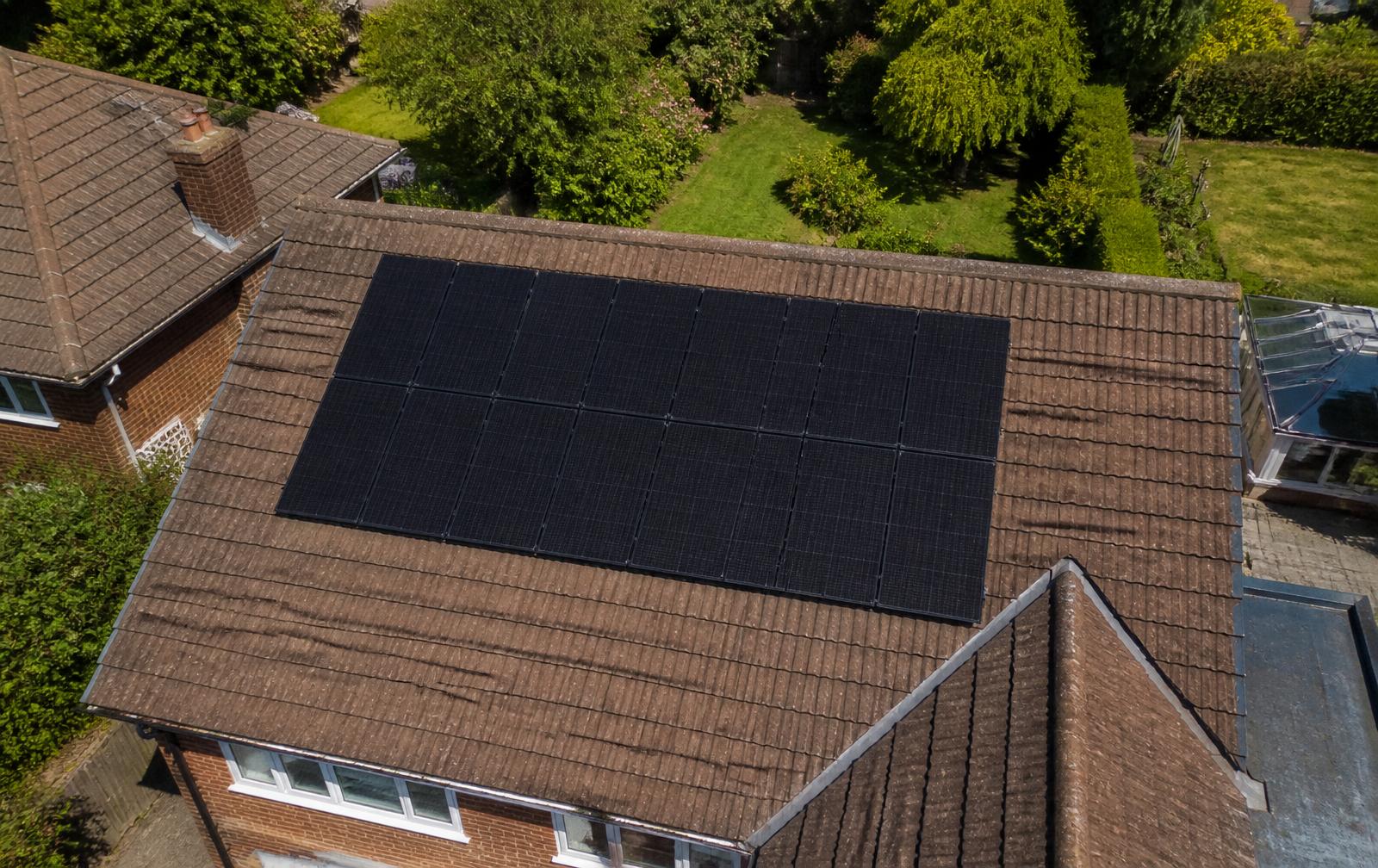 Aerial drone view of a residential solar panel array on a UK pitched roof, the type of imagery captured during a Solar Broker drone survey