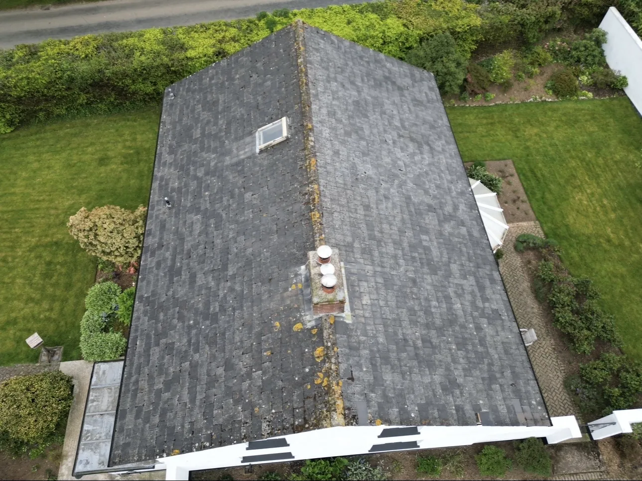 Drone view showing the roof and surrounding property